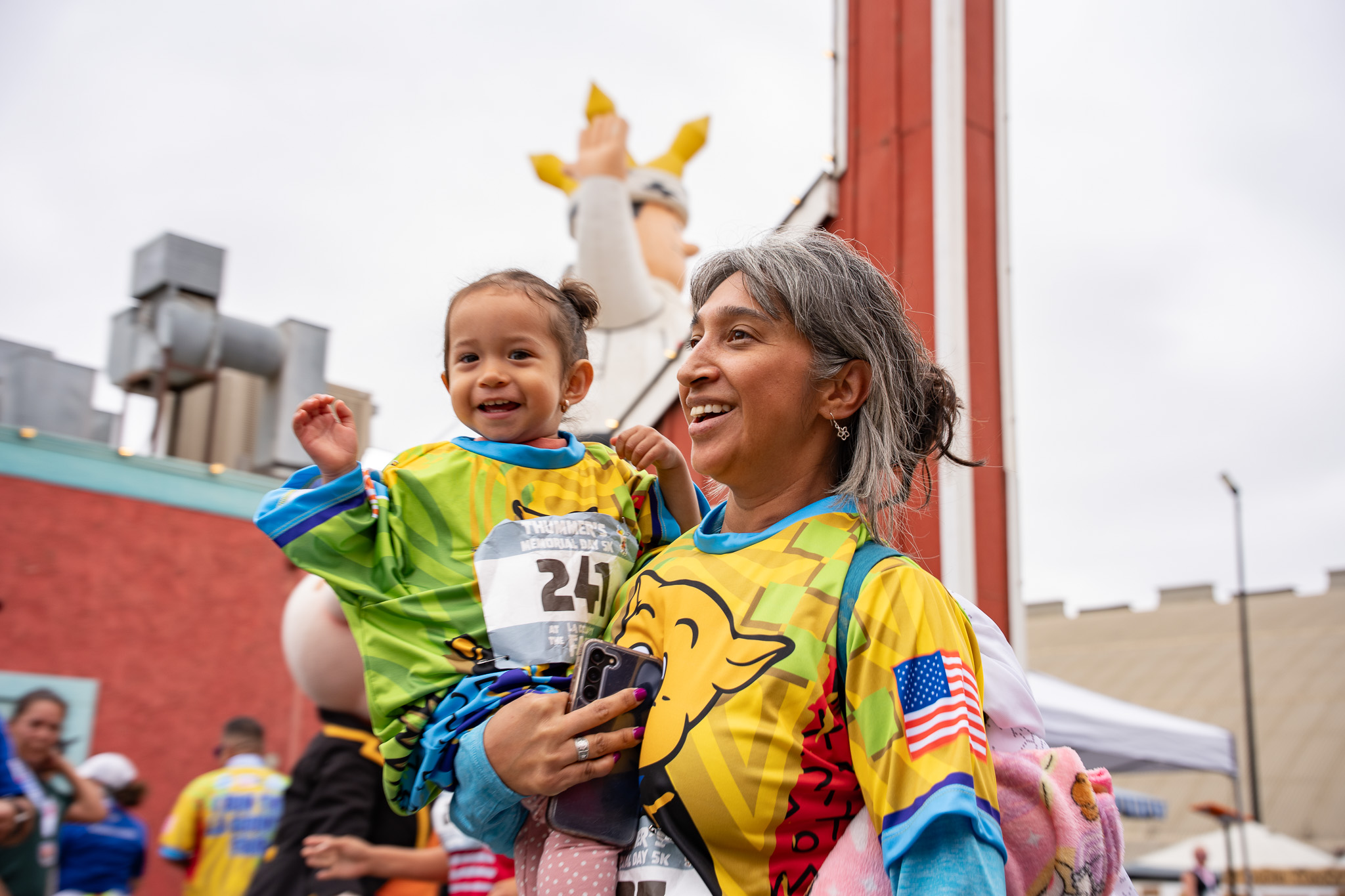 A mother and smiling toddler at the Memorial Day 5K in Pomona